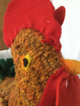 close up of head of rug hooked rooster sculpture